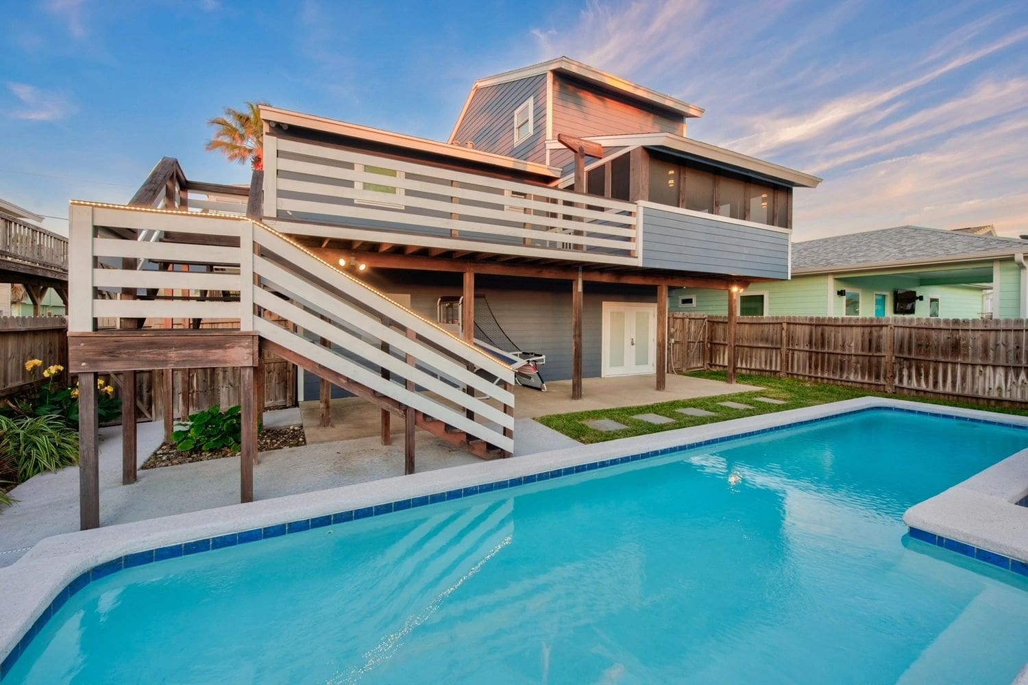 A pool with stairs leading to the deck.